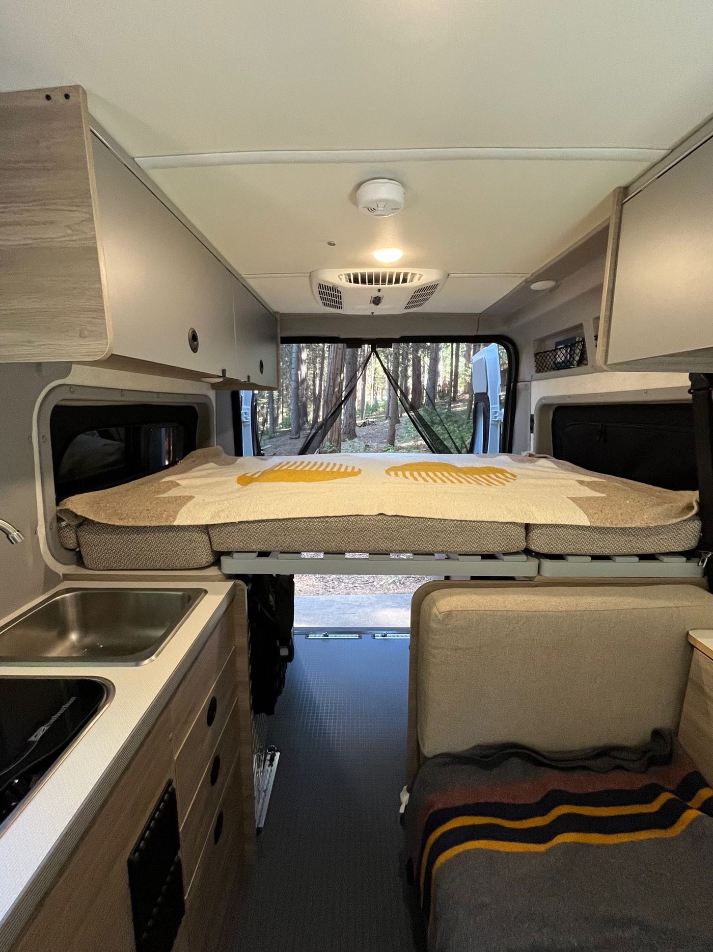  and ample storage for adaptable camping.|White RV rental van parked at night — photo 8