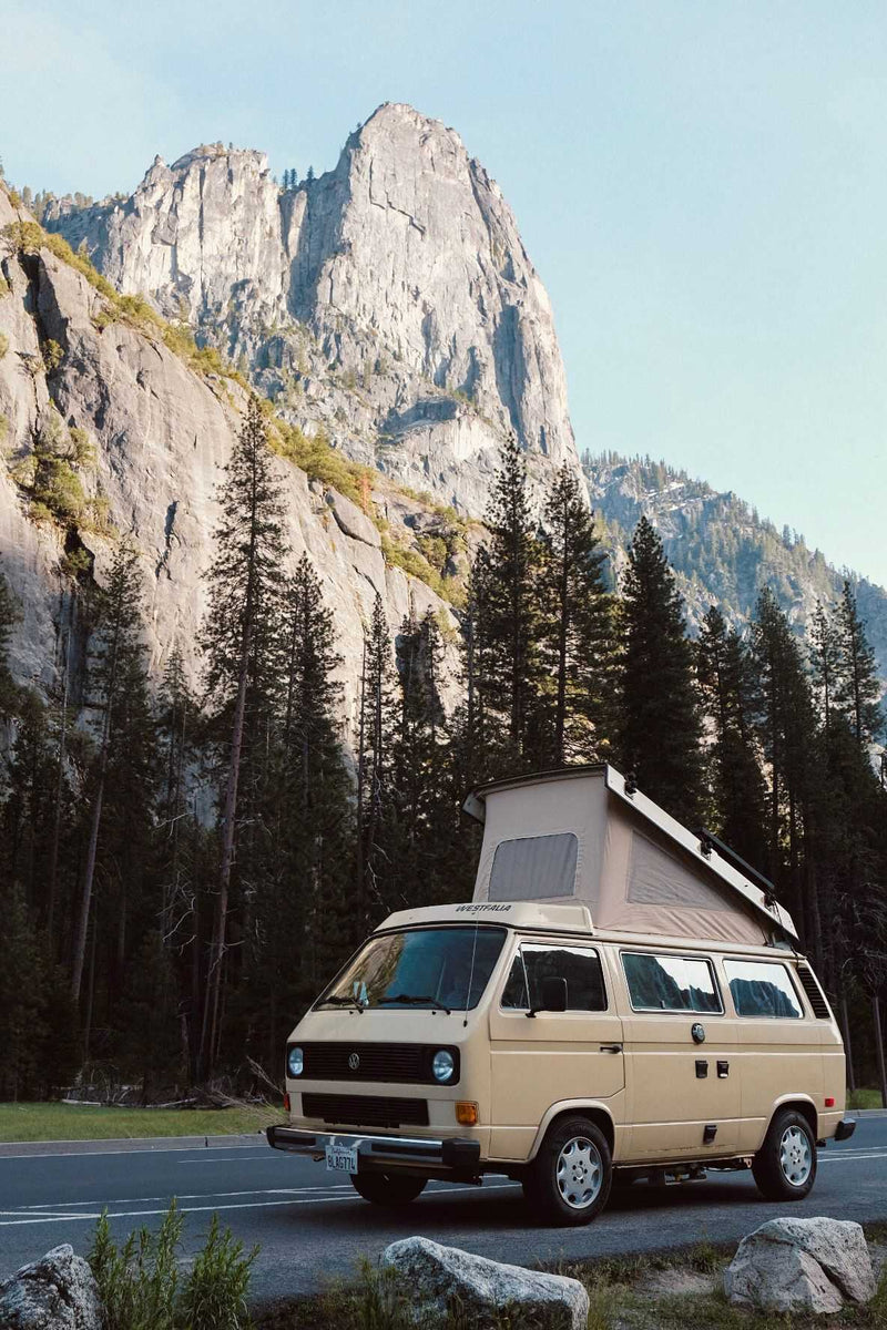  parked on a forest road. Ideal RV rental.|Explore San Francisco with an RV rental! A beige VW Westfalia parked by the Golden Gate Bridge — photo 3
