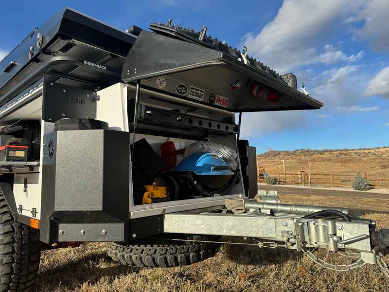 RV rental: Adventure-ready off-road camper trailer with open storage revealing gear. Perfect for outdoor exploration. — photo 3