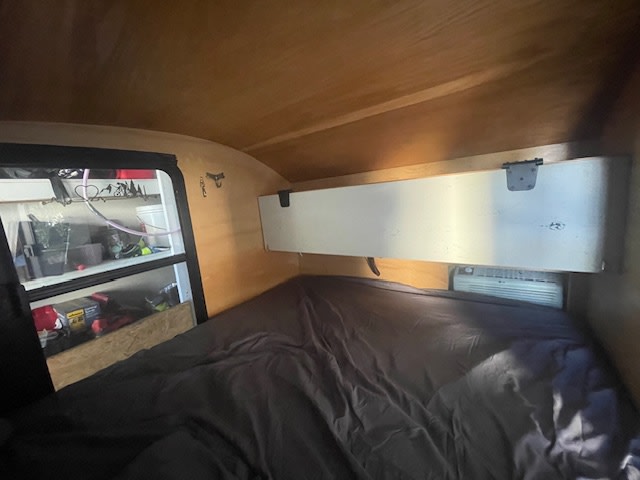  parked on green grass.|Rear of a white camper trailer available for RV rental