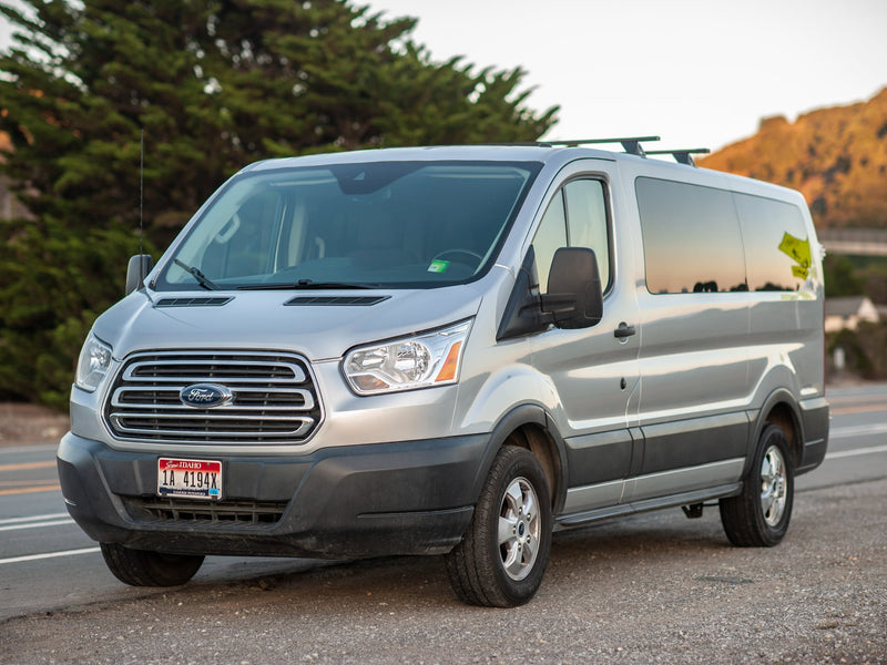  awaiting its next adventure.|Rear view of a silver Ford Transit 150 van — photo 5