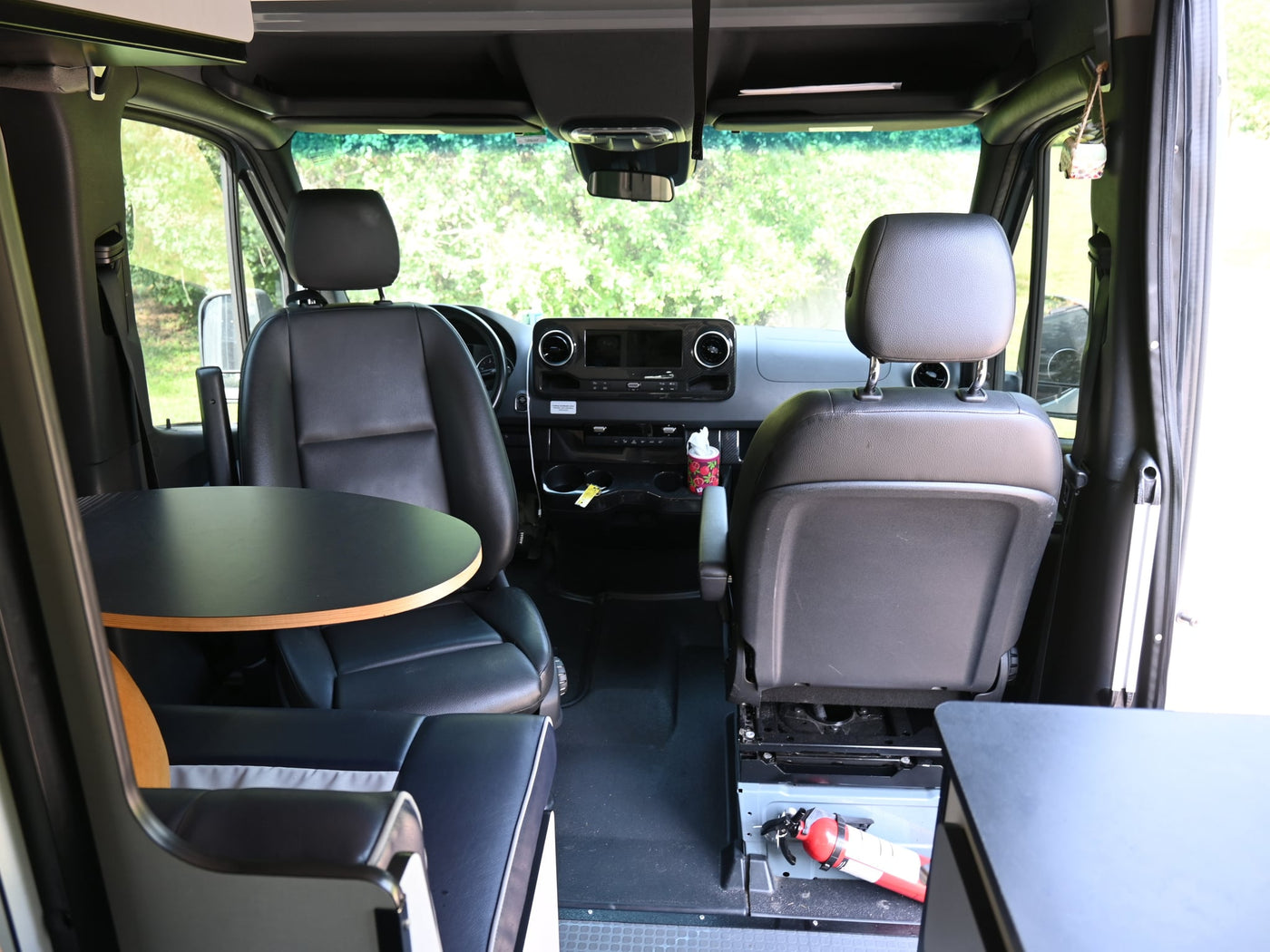  and seating for efficient living.|Modern RV rental interior with blue & white bench — photo 5