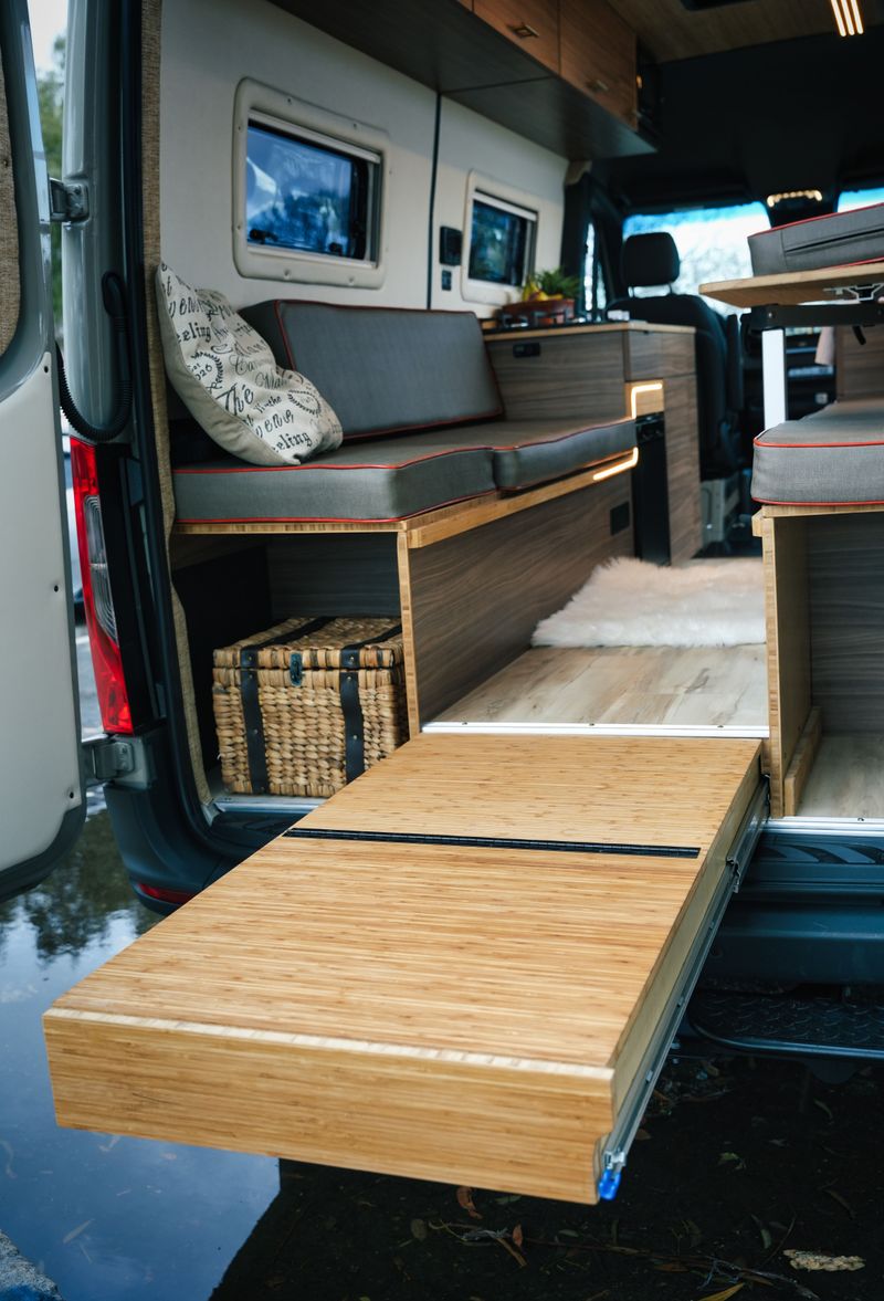  and dining space.|Inside a modern rv rental: warm wood interior — photo 5