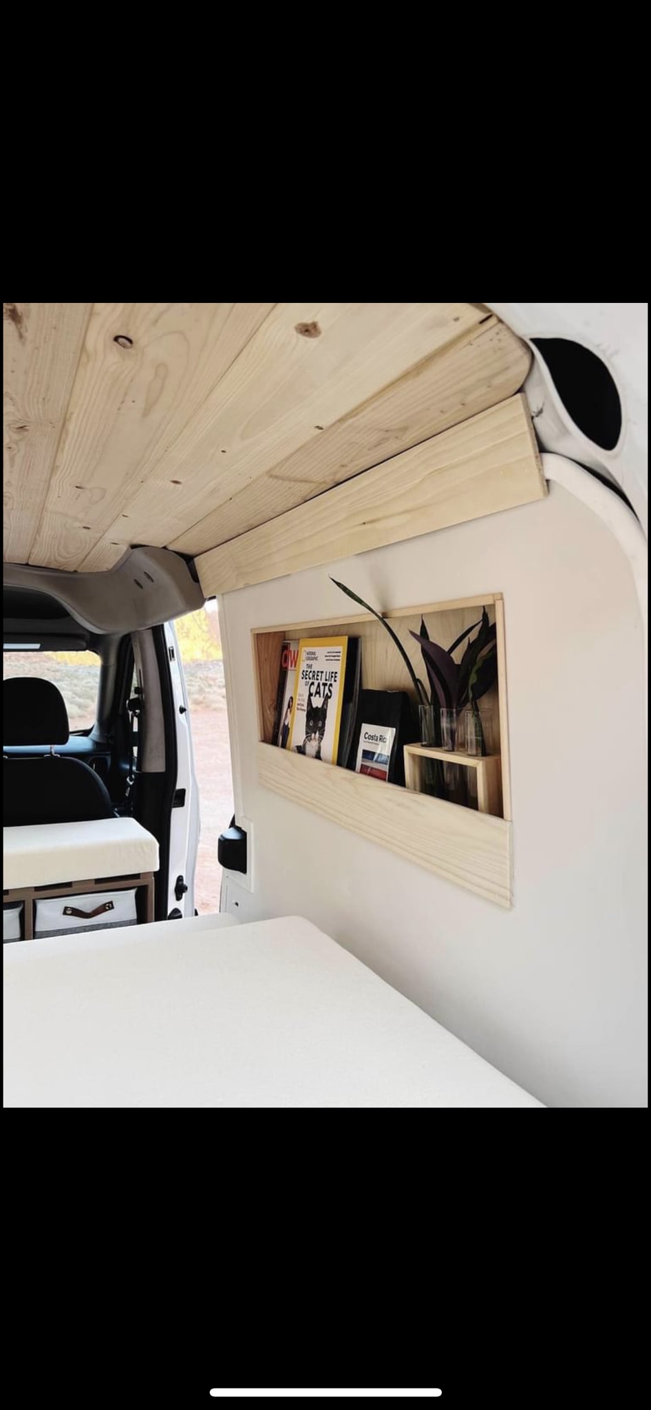  & interior storage/bed.|Portable outdoor shower setup on a white camper van
