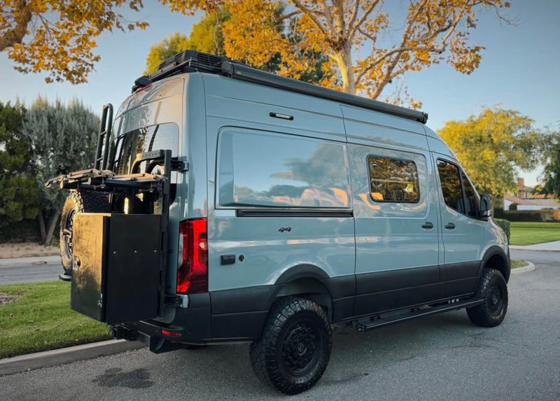 Adventure-ready gray camper van with off-road tires, roof rack & rear storage. Perfect for your RV rental journey. — photo 11