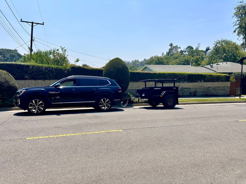 Explore outdoor adventures! Dark SUV tows a rugged XV-3 expedition trailer, perfect for RV rental trips on a sunny day. — photo 11