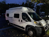 White Winnebago Solis camper van, ideal for your next RV rental adventure, parked at night.