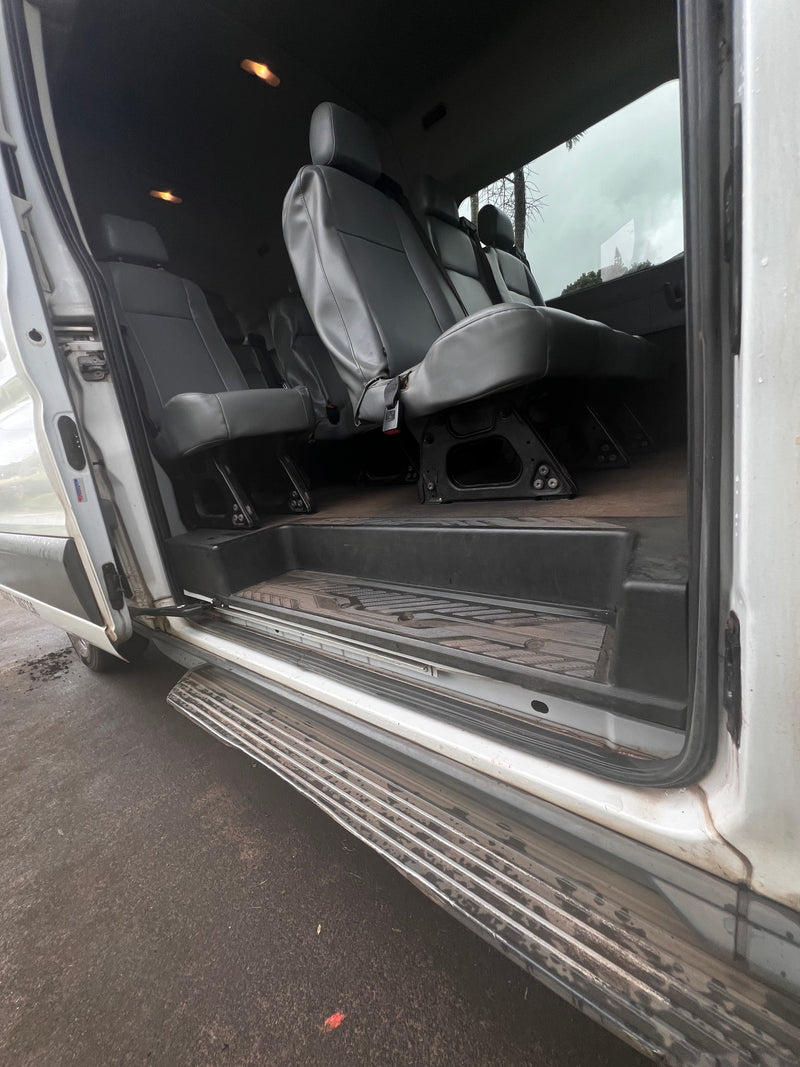  great for group travel or RV rental excursions. Features multiple rows of comfortable seats with seatbelts.|Spacious RV rental interior: Ford van cockpit with gray seats and a rainy tropical landscape view.|RV rental's dusty car radio console: media controls (radio — photo 11