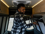  ready for adventure and comfortable travel.|Man organizes modular storage in an RV rental van