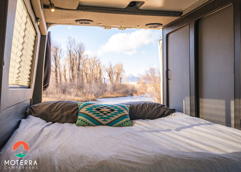 Enjoy nature from your cozy RV rental. This campervan features a comfy bed with a river view and ample storage. — photo 7