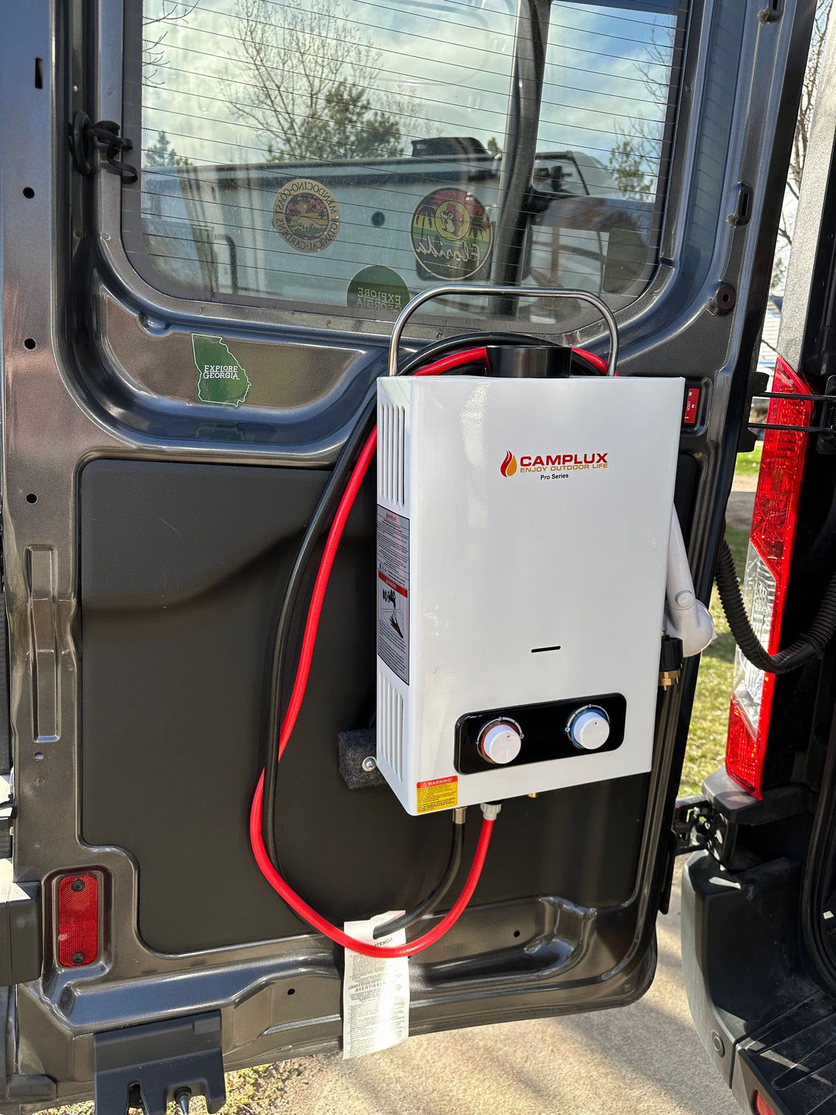 Portable Camplux water heater on an RV rental van door, perfect for outdoor showers & van life adventures. — photo 17