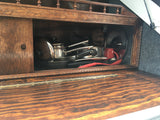 RV rental kitchen: a compact wooden cabinet showcasing neatly stored pots, pans, and utensils, perfect for travel cooking.
