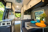 Step inside this modern rv rental: a well-equipped kitchenette, cozy dinette, and accessible controls. Your adventure begins!