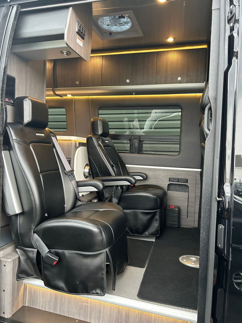 parked and charging its battery.|Black Airstream Sprinter RV rental with reflective windows and an awning — photo 4