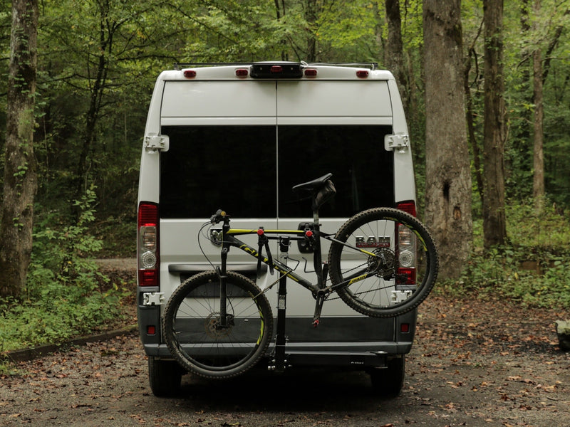  blue and cream mugs on a table. Nature outside.|White RV rental van with open rear doors and a mountain bike on a Kuat rack — photo 10