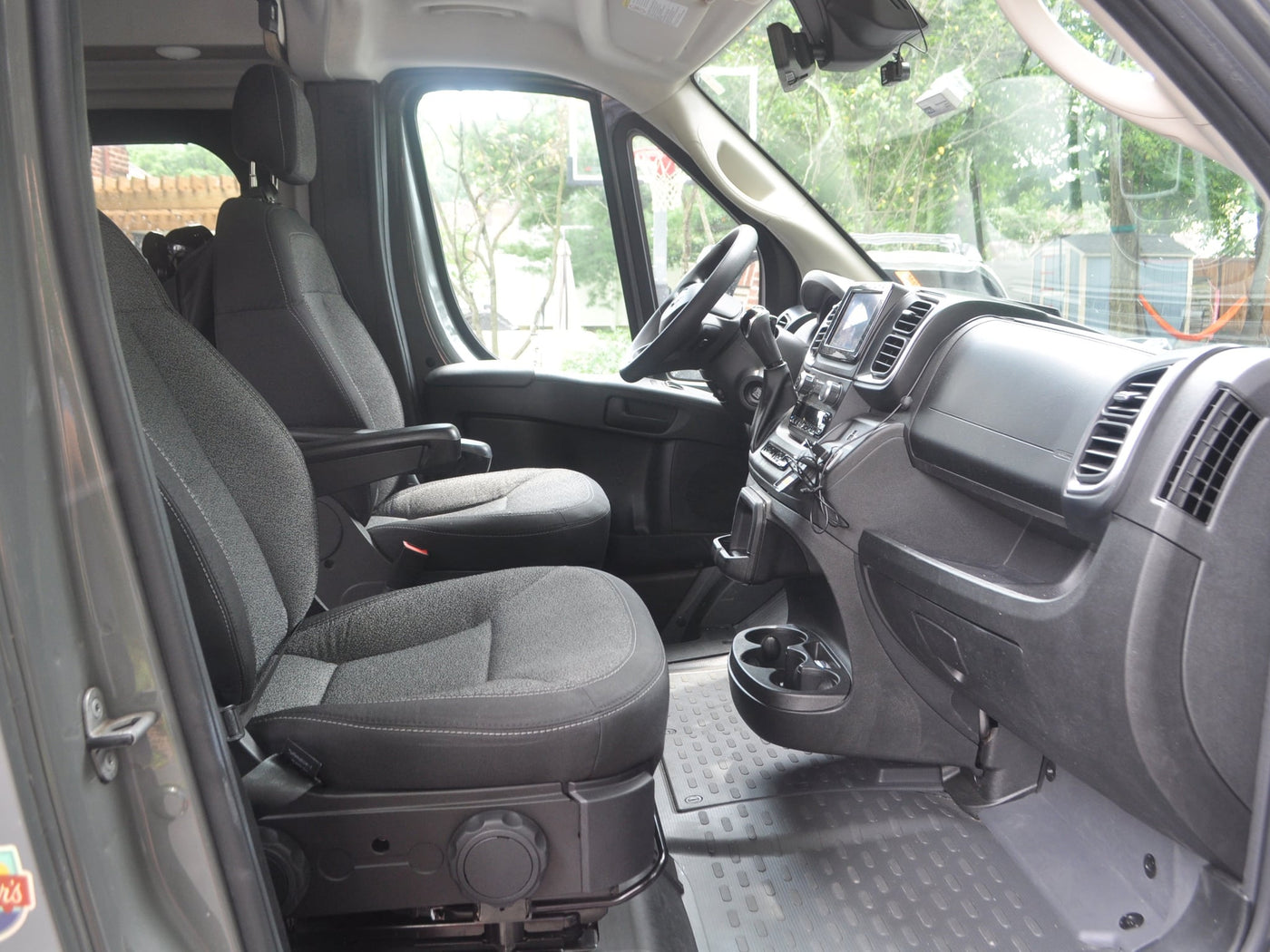  reflecting the vehicle's interior.|RV rental shower interior with white walls — photo 14