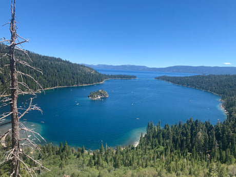 Scenic Emerald Bay, Lake Tahoe. Clear blue water, forested shores, and boats. Ideal for an RV rental trip.