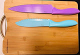 Colorful purple chef's knife & blue serrated knife on bamboo cutting board. Ideal kitchen tools for your RV rental.