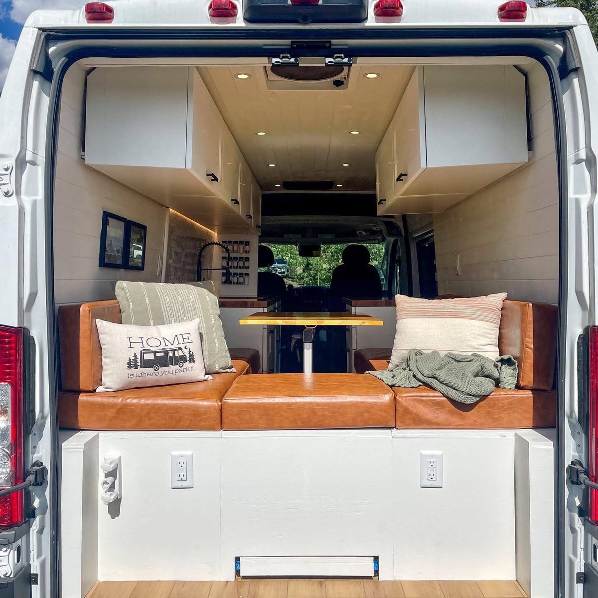  parked in the red desert of Monument Valley.|This rv rental shows a bright camper interior with a kitchen — photo 3