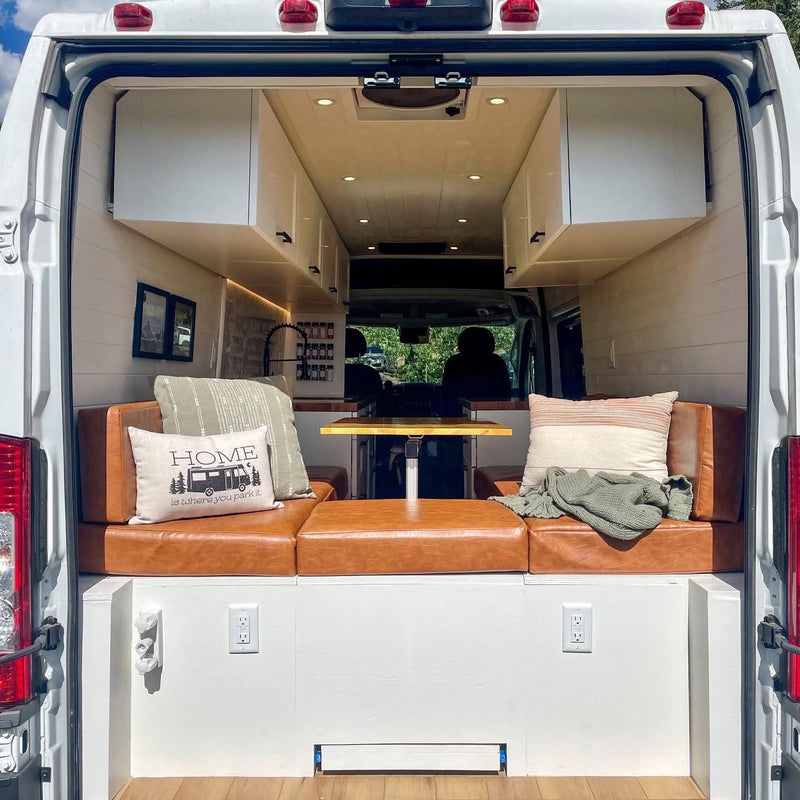  parked in the red desert of Monument Valley.|This rv rental shows a bright camper interior with a kitchen — photo 3