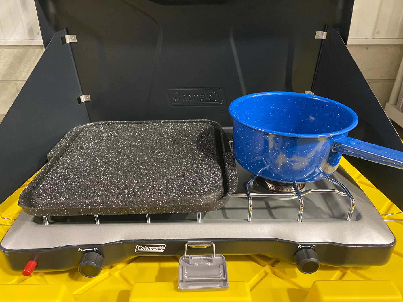 Coleman camp stove with a griddle and speckled blue pot, perfect for cooking in your RV rental. — photo 18