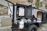 Compact RV rental camper with outdoor hot shower, pull-out kitchen, and cozy bed. Ideal for off-grid adventures.