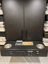 RV rental: multi-functional interior unit featuring storage, power outlets, USB, voltage display, and cup holders.