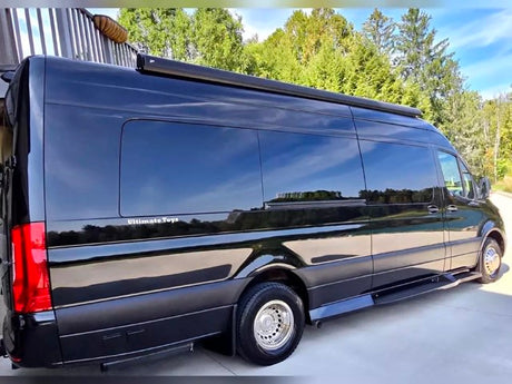 Black Mercedes-Benz Sprinter luxury RV rental van with tinted windows and awning. Ideal for your next road trip adventure.