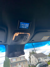 Experience modern comfort in your RV rental with this overhead digital control panel for climate, lighting, and entertainment systems.