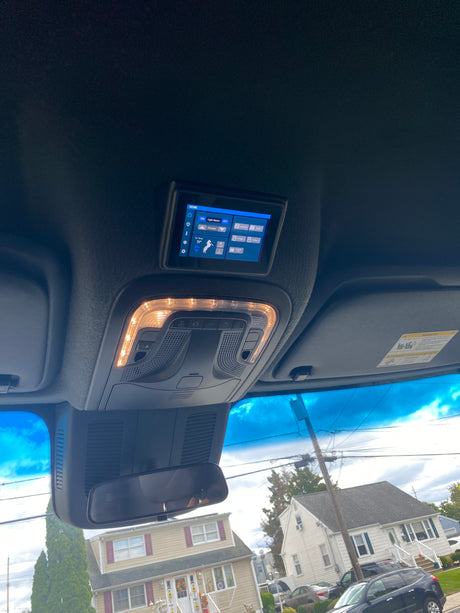 Experience modern comfort in your RV rental with this overhead digital control panel for climate, lighting, and entertainment systems.