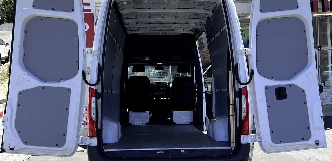 White cargo van with rear doors open, revealing an empty interior, ideal for RV rental conversion. — photo 6