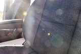 Inside an RV rental: a sunlit passenger seat, highlighting its textured fabric and armrest. Ready for adventure!