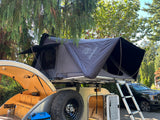Explore with this teardrop trailer & iKamper rooftop tent setup, complete with kitchen. Ideal RV rental for camping adventures!