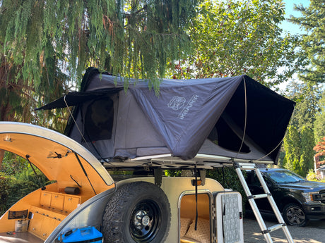 Explore with this teardrop trailer & iKamper rooftop tent setup, complete with kitchen. Ideal RV rental for camping adventures!