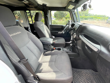 View inside a Jeep Wrangler Sahara. Note the 'SINCE 1941' handle. An agile choice for your adventure, different from a typical RV rental.