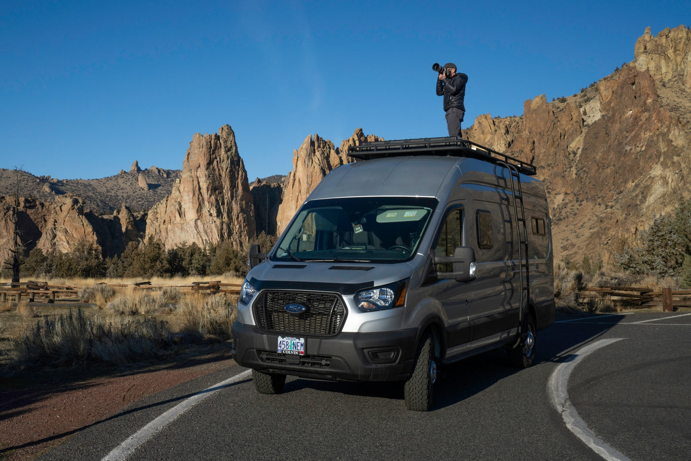 An RV rental provides the perfect vantage for a photographer to capture stunning, rugged landscapes from atop a customized Ford Transit van. — photo 3