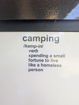 A humorous sticker defines "camping": "spending a small fortune to live like a homeless person." A pricey RV rental relates!