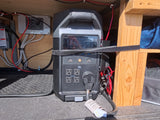 Portable power station and generator switch setup in an RV rental. Essential electrical management for off-grid adventures.
