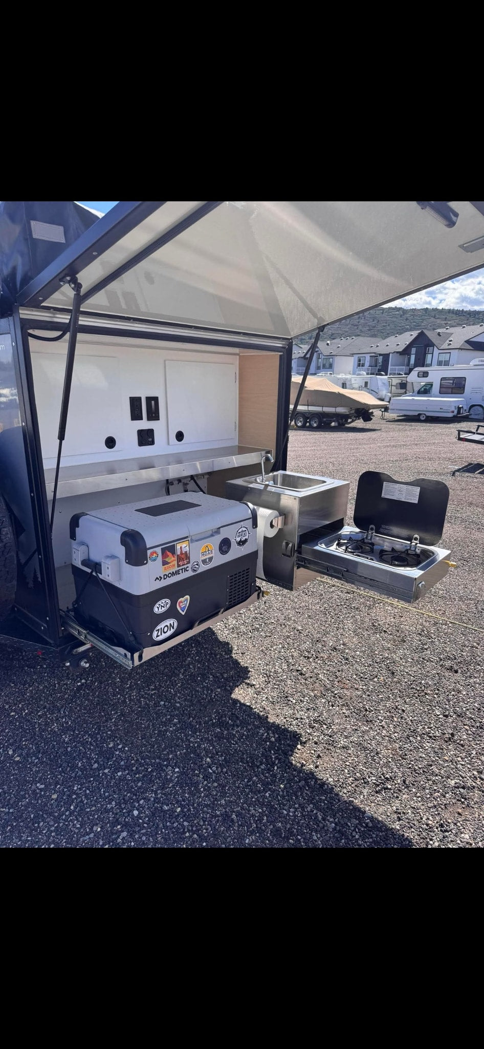 Explore camping with this rv rental! Features a pull-out outdoor kitchen: Dometic fridge, sink, and stove for cooking on the go. — photo 7