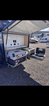 Explore camping with this rv rental! Features a pull-out outdoor kitchen: Dometic fridge, sink, and stove for cooking on the go.
