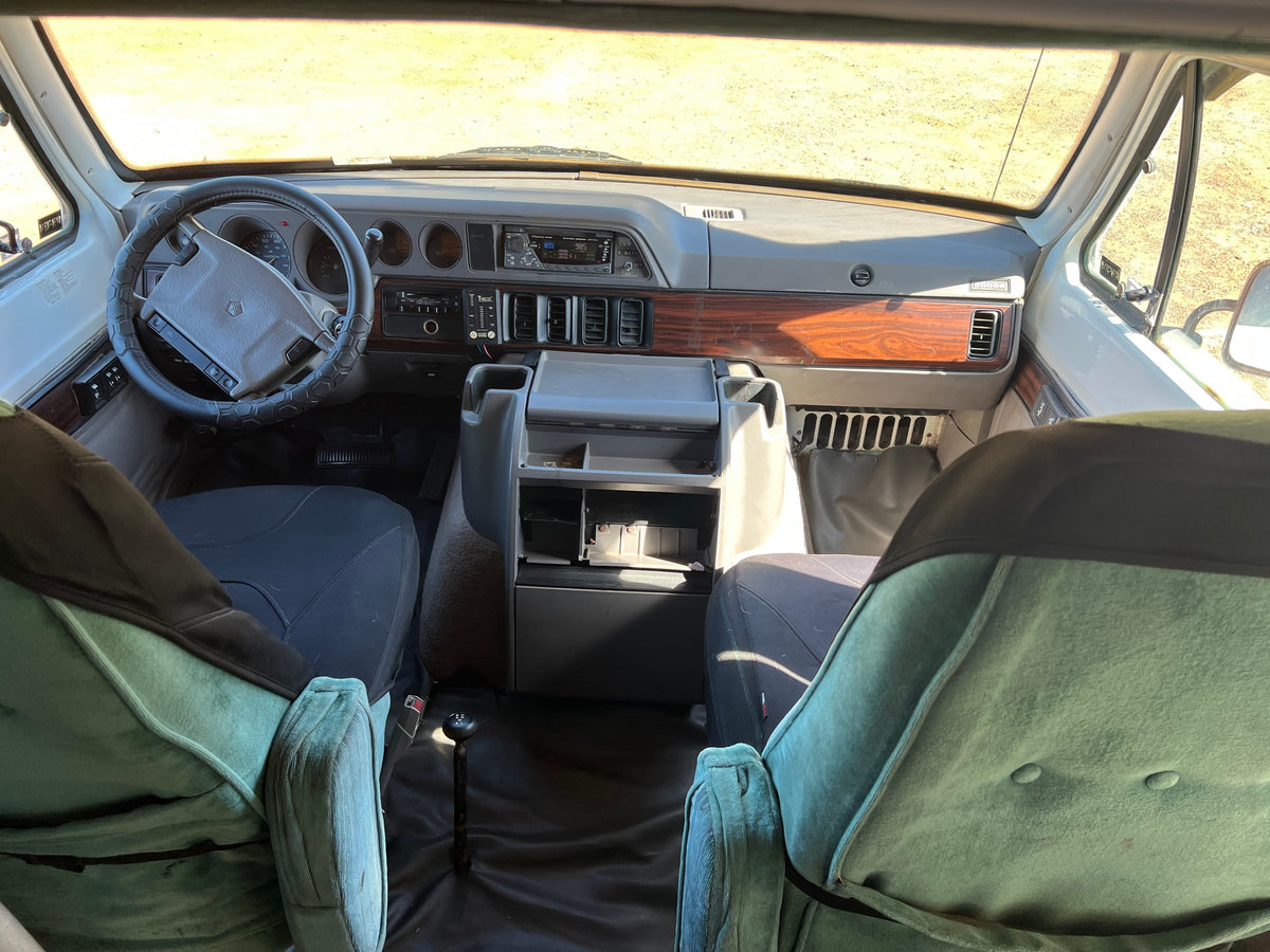  and wooden floor for cozy travel.|An RV rental's van life interior featuring a comfortable bed — photo 19