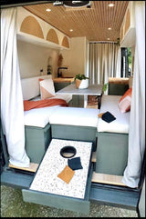 This RV rental camper van boasts a stylish interior with cozy seating, kitchen, and a pull-out cornhole game at the rear.