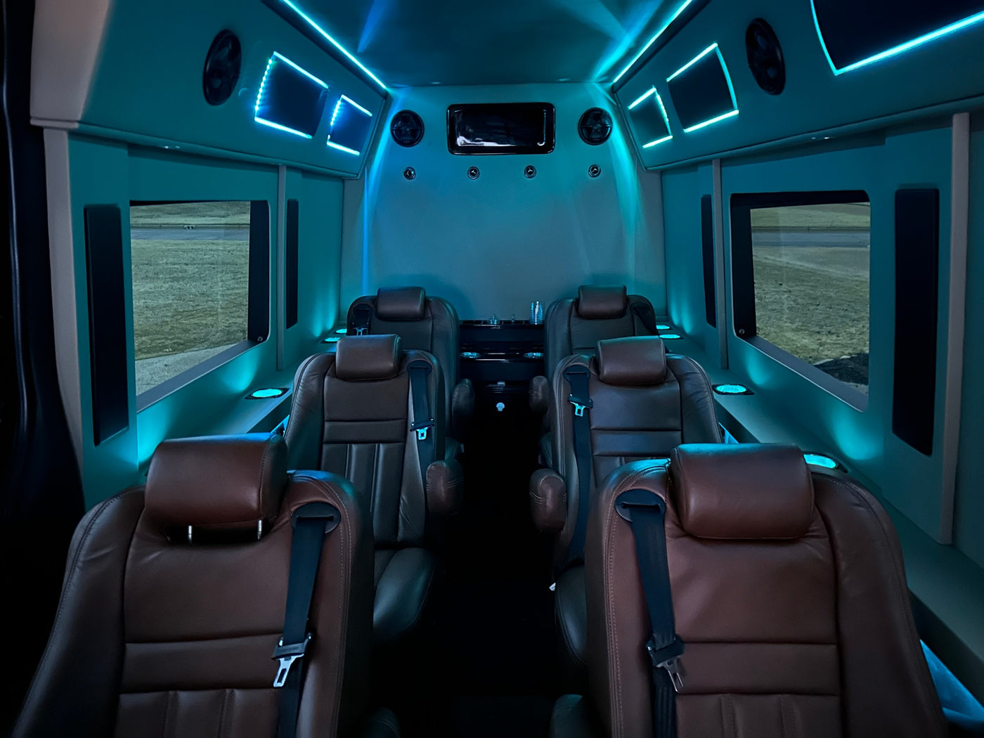  featuring ambient blue lighting & entertainment.|Luxury RV rental interior with a large TV showing Netflix — photo 4