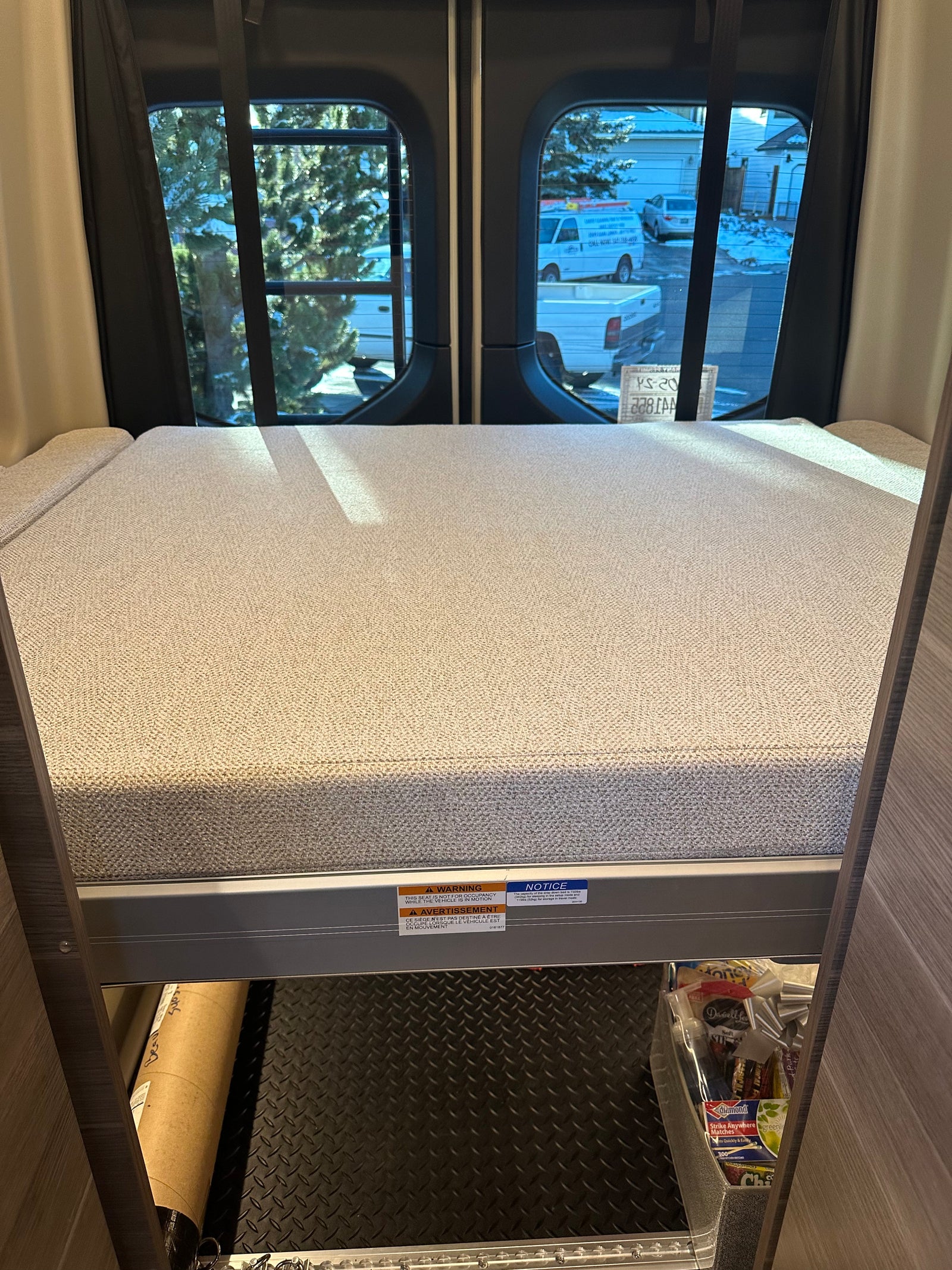 RV rental interior features a cozy bunk bed with under-bed storage, including a diamond plate floor for gear.