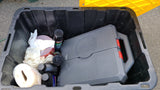 Inside an RV rental storage bin: a Crescent tool kit, brake cleaner, and paper towels for essential upkeep.