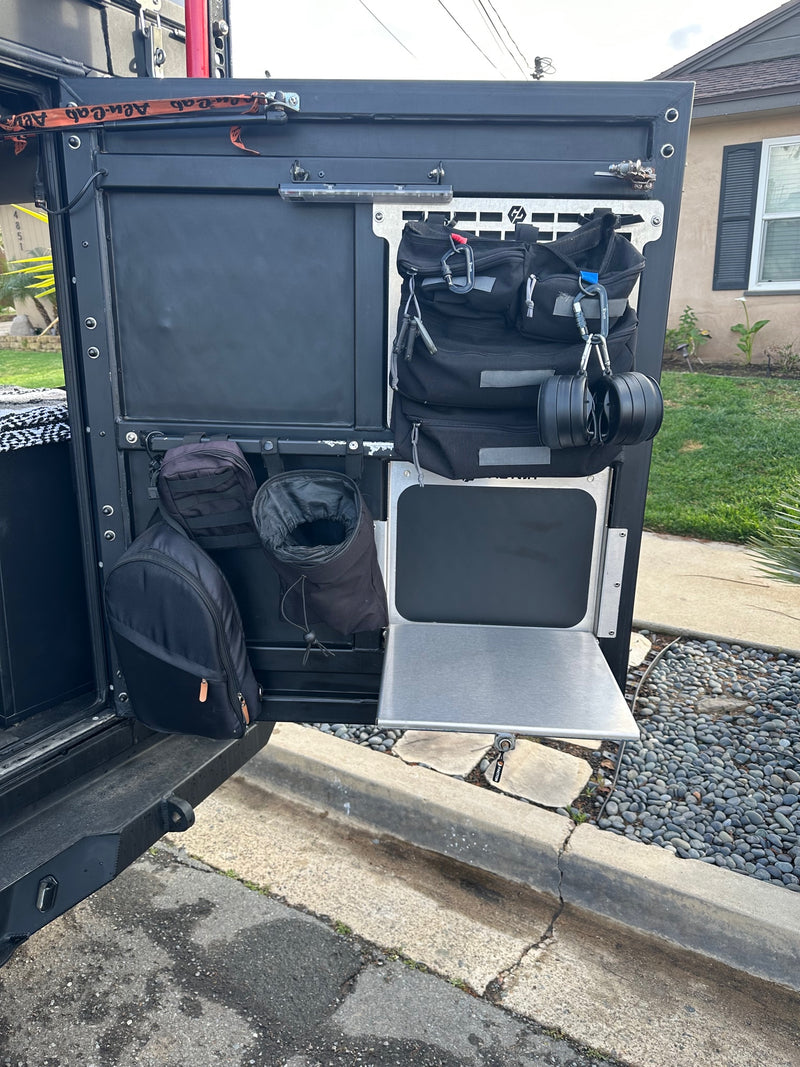 Explore with this RV rental's organized tailgate: drop table, modular storage for bags, and essential overland gear. — photo 16