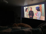 Relaxing at home, enjoying a show on the large screen with my sleeping dog, creating a cozy RV rental vibe.