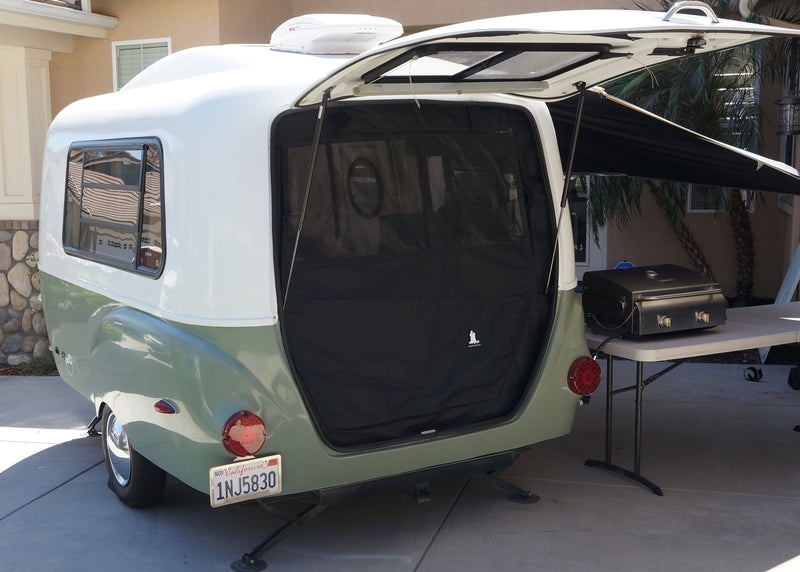 Teardrop RV rental: rear galley open to an outdoor kitchen setup with a Cuisinart grill, ready for travel. — photo 4