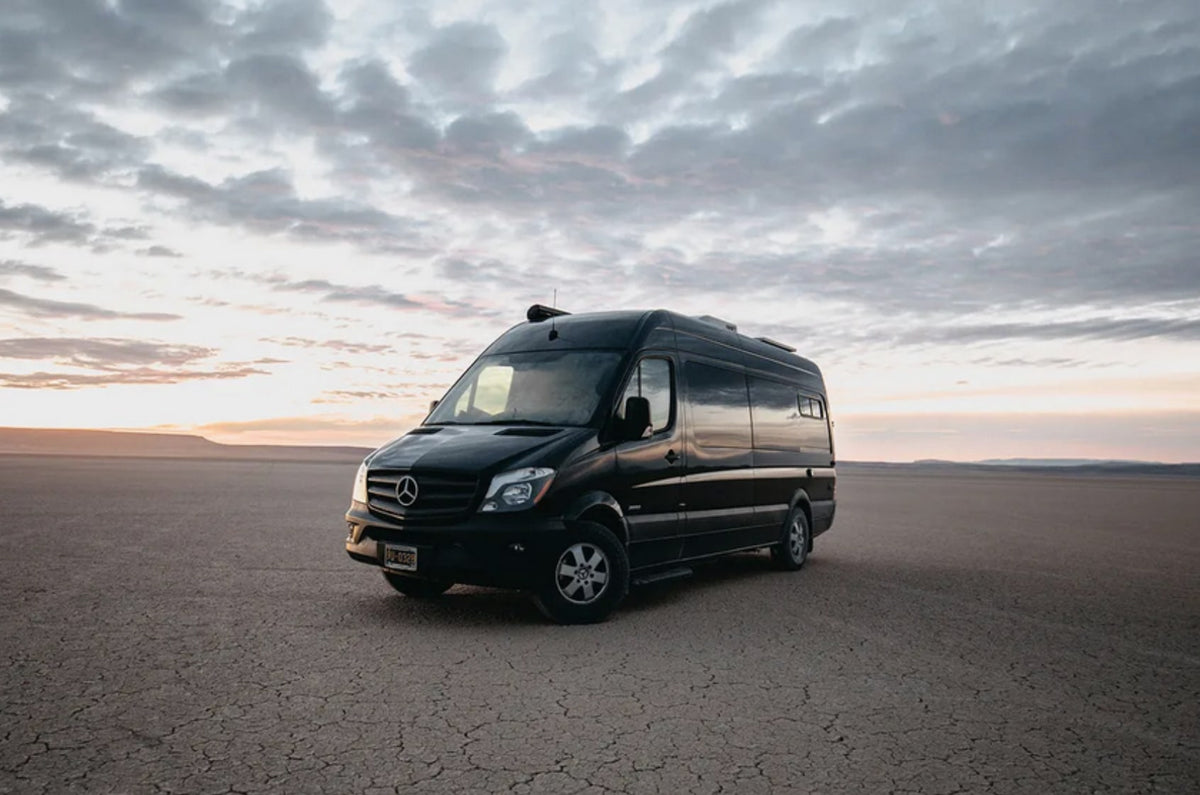 Black Mercedes Sprinter camper van rv rental on a vast