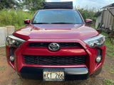 Front view: Red Toyota SUV with roof cargo bag, Hawaii plate KCT 266. Great for an rv rental road trip.